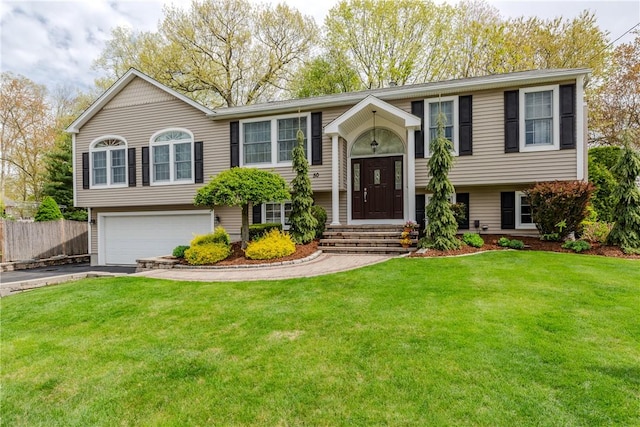 bi-level home featuring an attached garage and driveway