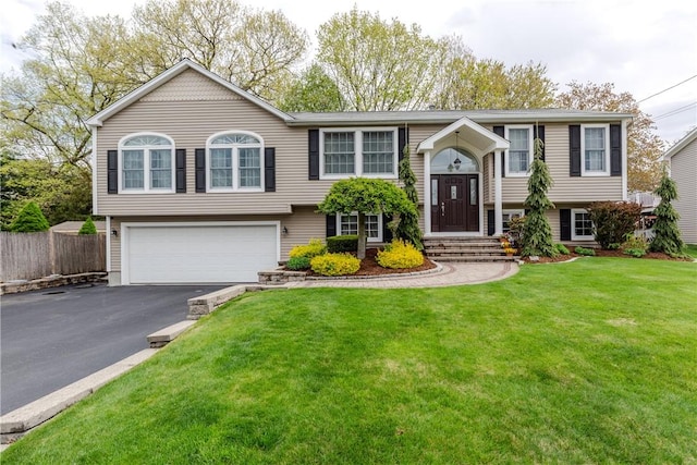 bi-level home with a garage and driveway