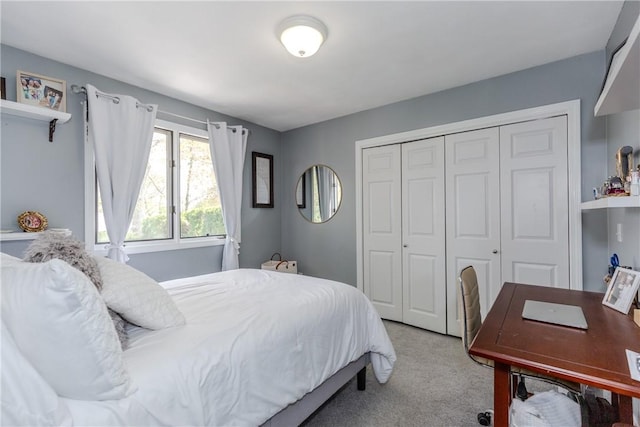 bedroom featuring light colored carpet and a closet
