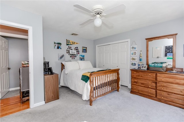 bedroom with light carpet, a closet, a ceiling fan, and baseboards