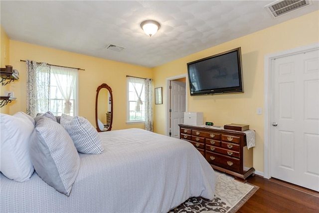 bedroom with dark wood-type flooring and baseboards
