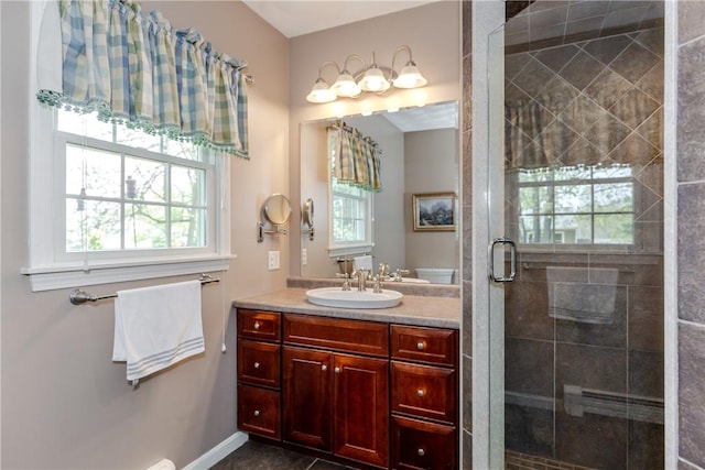 bathroom featuring a shower stall, vanity, and baseboards
