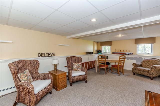 sitting room with carpet flooring, wainscoting, a baseboard heating unit, a paneled ceiling, and recessed lighting