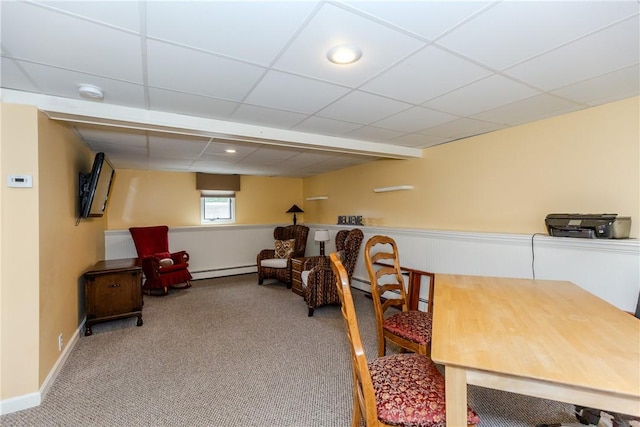 dining room featuring a baseboard radiator, carpet, a drop ceiling, and baseboards