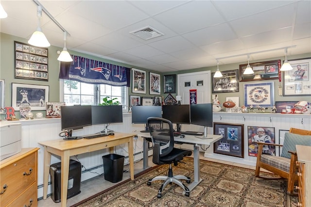 office area with a drop ceiling and baseboard heating