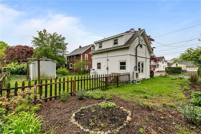 back of property with a storage shed and an outbuilding