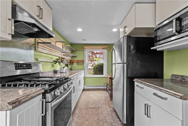 kitchen featuring appliances with stainless steel finishes, under cabinet range hood, baseboard heating, white cabinetry, and recessed lighting