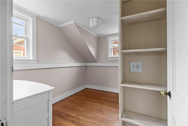 additional living space featuring wood finished floors and baseboards