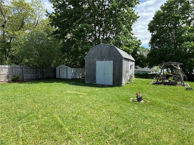 view of yard with a storage shed and an outbuilding
