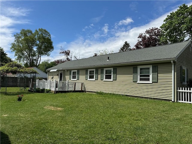 rear view of house featuring a shingled roof