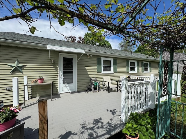 back of house featuring a wooden deck