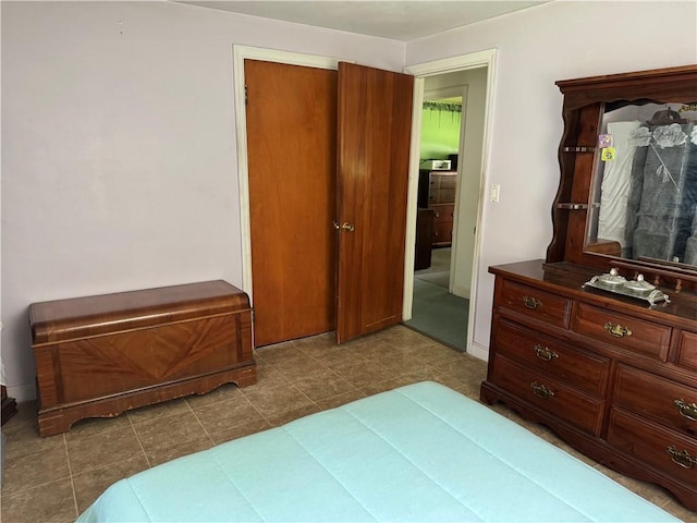 bedroom with dark tile patterned flooring