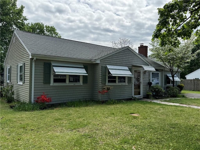 bungalow-style house featuring a chimney and roof with shingles