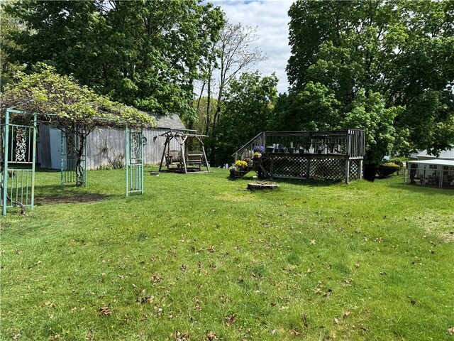 view of yard featuring a deck and a playground