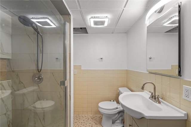 37 Pinewood Dr, North Providence, RI 02904 - full bathroom with toilet, a stall shower, a paneled ceiling, tile walls, and vanity