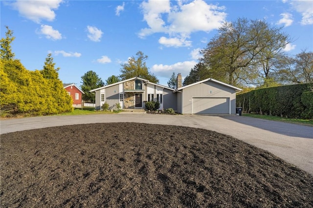 37 Pinewood Dr, North Providence, RI 02904 - mid-century modern home with concrete driveway, a chimney, and a garage