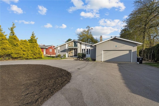 37 Pinewood Dr, North Providence, RI 02904 - mid-century home with driveway, a garage, a chimney, and stone siding