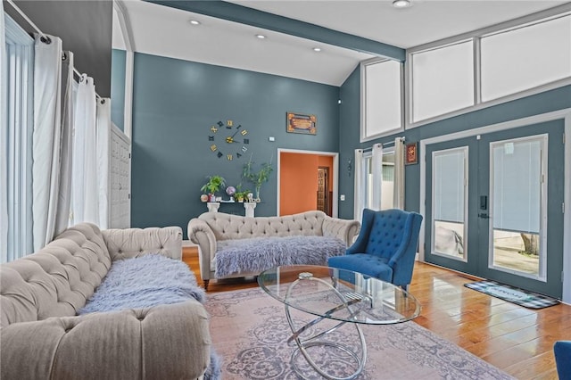 37 Pinewood Dr, North Providence, RI 02904 - living room featuring french doors, light wood-type flooring, high vaulted ceiling, healthy amount of natural light, and beamed ceiling