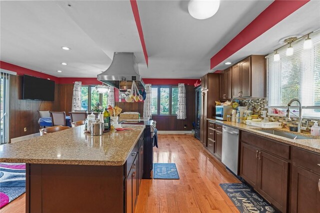 37 Pinewood Dr, North Providence, RI 02904 - kitchen with dishwasher, a sink, light wood finished floors, a center island, and light stone counters