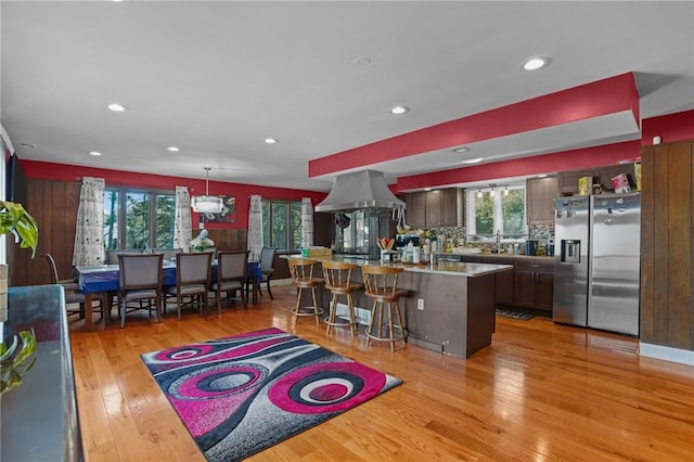 37 Pinewood Dr, North Providence, RI 02904 - kitchen featuring stainless steel refrigerator with ice dispenser, light wood-style floors, plenty of natural light, recessed lighting, and a kitchen bar
