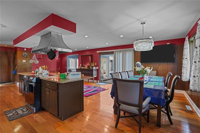 37 Pinewood Dr, North Providence, RI 02904 - kitchen with range with electric cooktop, island exhaust hood, a chandelier, light wood-type flooring, and a center island