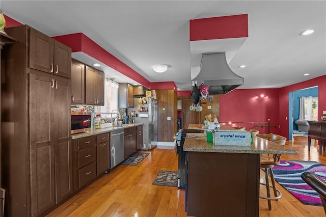 37 Pinewood Dr, North Providence, RI 02904 - kitchen with island range hood, appliances with stainless steel finishes, a kitchen bar, a center island, and light wood-style flooring