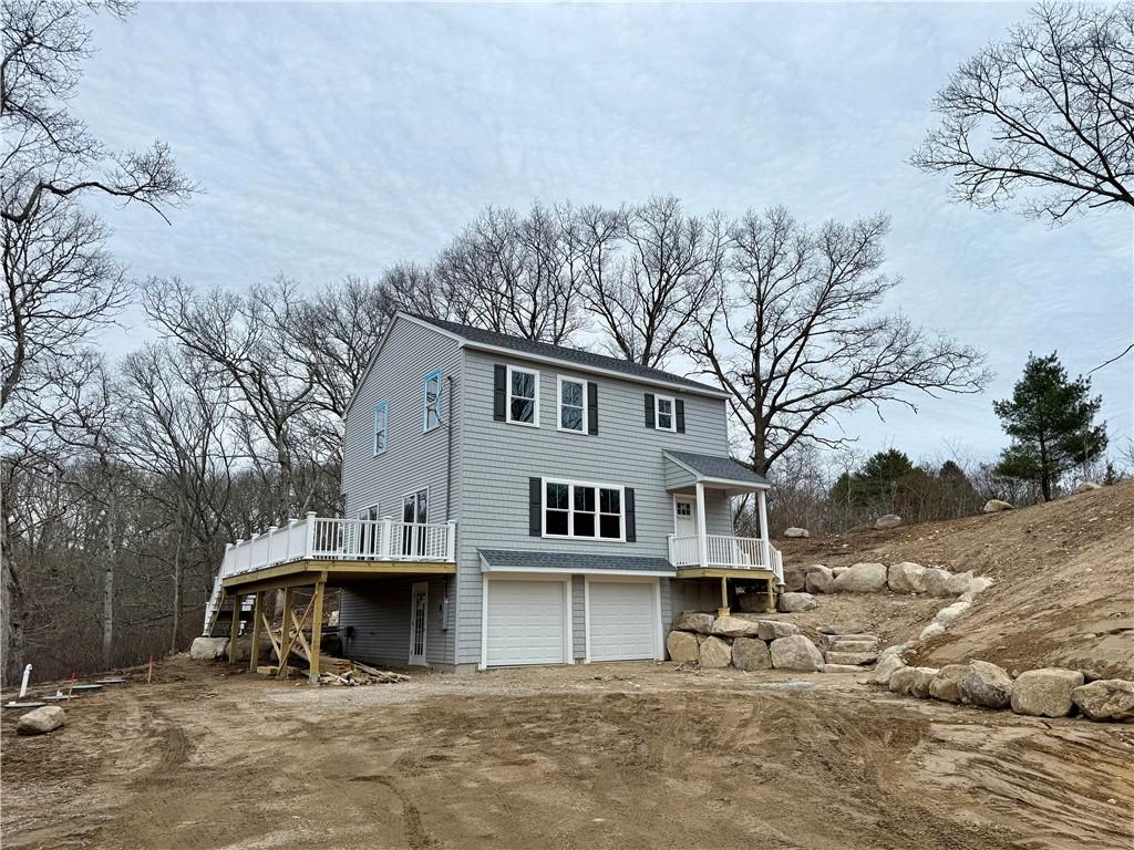 322 Post Rd, Westerly, RI 02891 - back of house featuring a garage, dirt driveway, and a deck