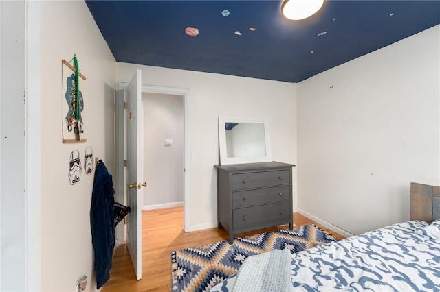 bedroom featuring wood finished floors and baseboards