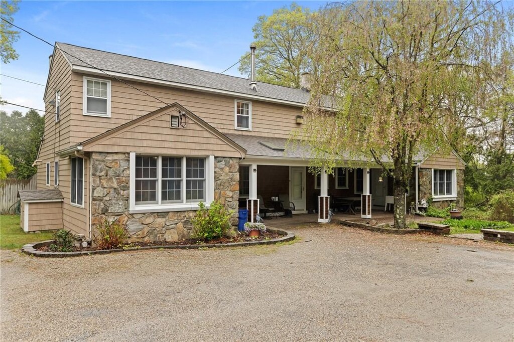 24 Golden View Dr, Johnston, RI 02919 - view of front facade featuring stone siding, a chimney, roof with shingles, and a porch