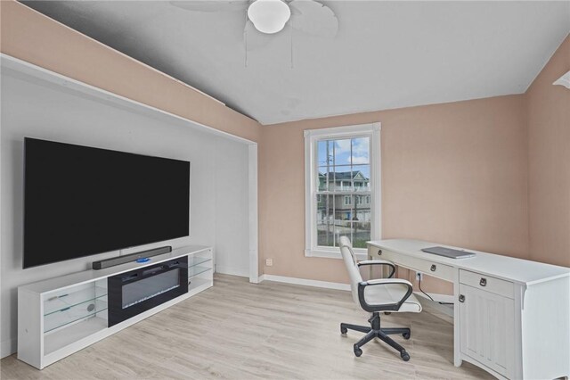 office space featuring light wood-type flooring, lofted ceiling, baseboards, and ceiling fan