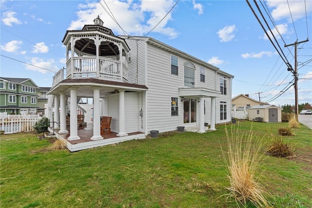 back of property with a balcony