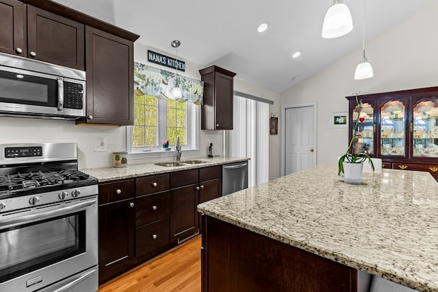 1740 Bulgarmarsh Rd, Tiverton, RI 02878 - kitchen featuring stainless steel appliances, a sink, lofted ceiling, light wood-style flooring, and light stone countertops