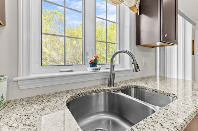 1740 Bulgarmarsh Rd, Tiverton, RI 02878 - kitchen view of a sink, dark brown cabinets, and light stone counters