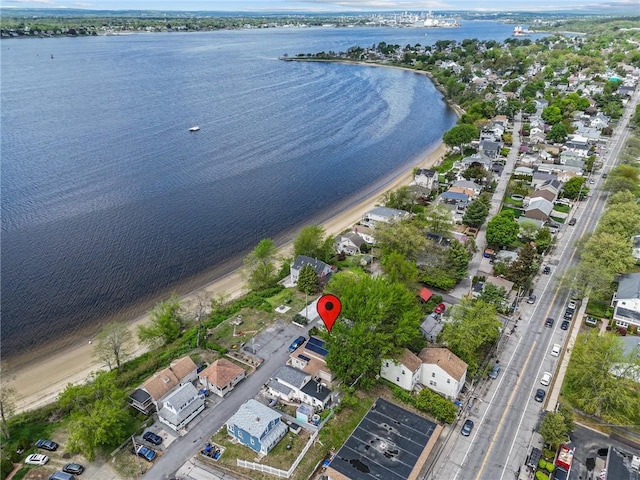 aerial overview of property's location featuring a large body of water and nearby suburban area