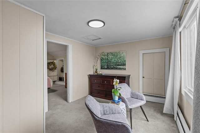 living area featuring baseboard heating and light carpet