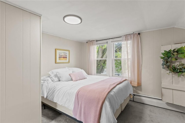 bedroom featuring a decorative wall and a baseboard heating unit