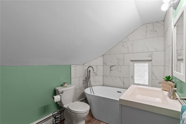 bathroom with vaulted ceiling, a soaking tub, toilet, baseboard heating, and vanity