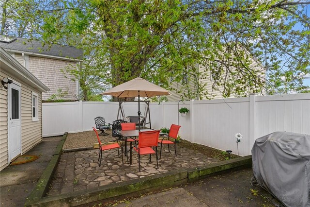 view of patio / terrace with a fenced backyard, grilling area, and outdoor dining space