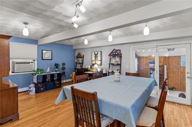 dining space with cooling unit, a baseboard radiator, beamed ceiling, and light wood-type flooring