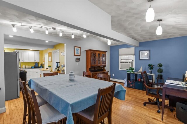 dining space with a baseboard radiator, light wood-type flooring, cooling unit, and track lighting