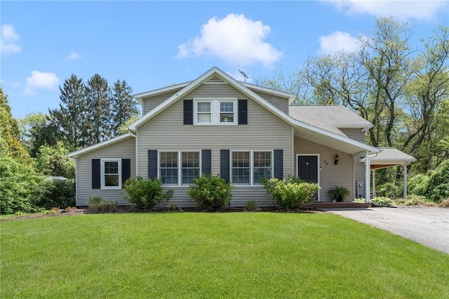 traditional-style house with a front lawn and driveway