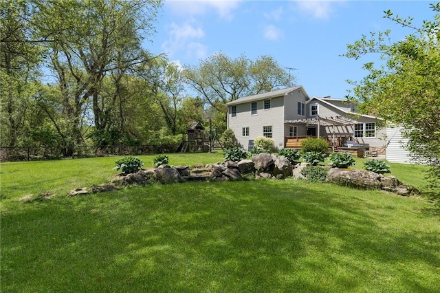 view of yard with a playground and a wooden deck