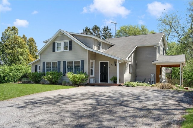 view of front of property with asphalt driveway