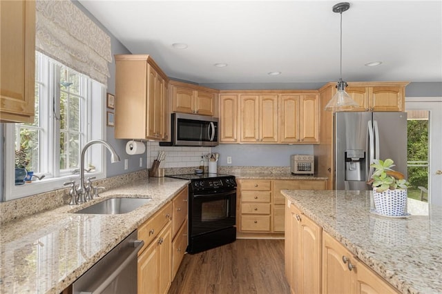 kitchen featuring appliances with stainless steel finishes, a sink, dark wood-style flooring, light stone countertops, and light brown cabinets