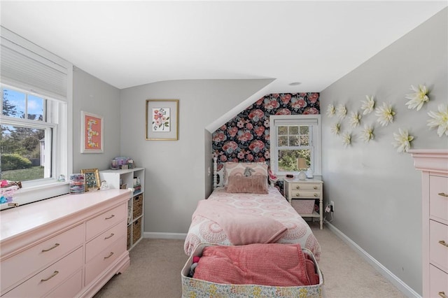 bedroom featuring multiple windows, light colored carpet, baseboards, and vaulted ceiling
