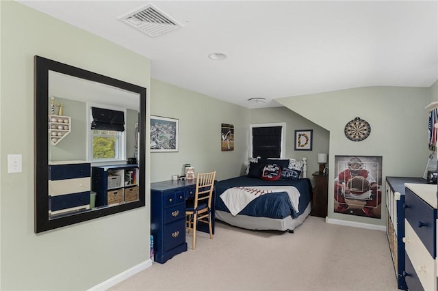 bedroom featuring light carpet and baseboards