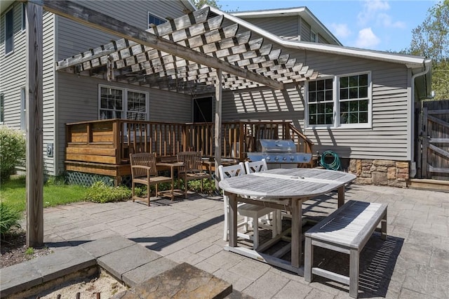 view of patio / terrace featuring grilling area, a pergola, and outdoor dining area