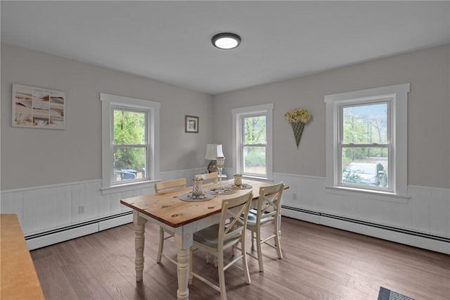 183 Annaquatucket Rd, North Kingstown, RI 02852 - dining room with a baseboard radiator, wainscoting, plenty of natural light, and wood finished floors