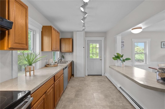 183 Annaquatucket Rd, North Kingstown, RI 02852 - kitchen with stainless steel dishwasher, a baseboard radiator, a sink, track lighting, and brown cabinetry