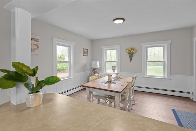 183 Annaquatucket Rd, North Kingstown, RI 02852 - dining room with a baseboard heating unit, wainscoting, plenty of natural light, and wood finished floors